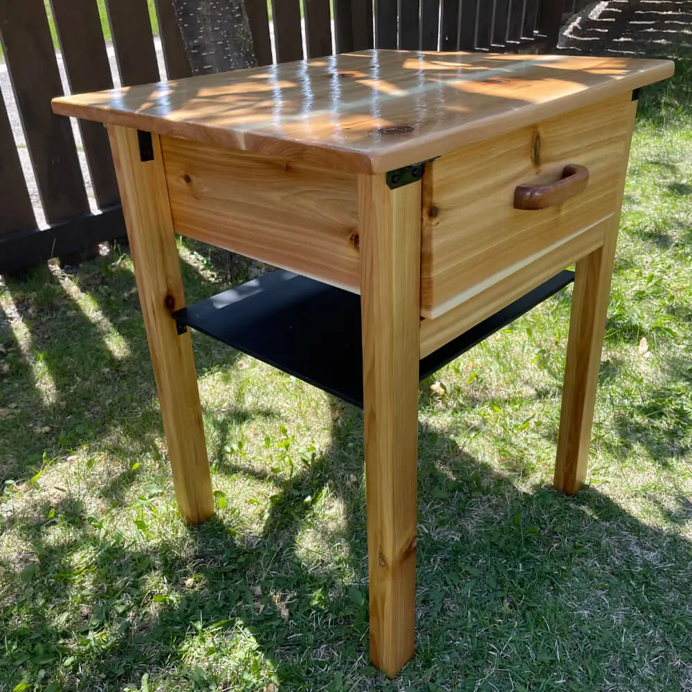 A wooden nightstand made with cedar fence slats
